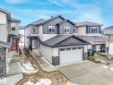 The property features a two-story design with light-colored siding and dark accents - 14 Dalquist Bay, Leduc, AB  - Outdoor 