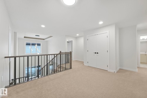 This expansive upper level features plush carpeting, a closet with double doors, and recessed lighting - 14 Dalquist Bay, Leduc, AB - Indoor Photo Showing Other Room