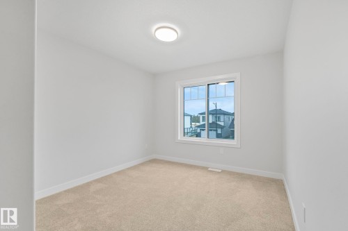 This room features a window providing natural light, light-colored walls, and carpeting - 14 Dalquist Bay, Leduc, AB - Indoor Photo Showing Other Room