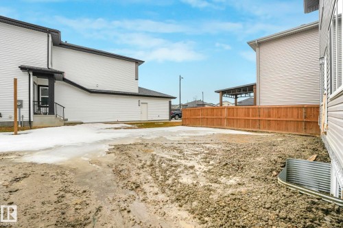 The property features a private yard space with a wooden fence - 14 Dalquist Bay, Leduc, AB - Outdoor With Exterior