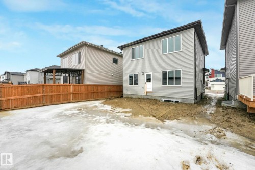 The property features a two-story exterior with light gray siding and white-trimmed windows - 14 Dalquist Bay, Leduc, AB - Outdoor With Exterior