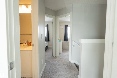 Hallway featuring light gray walls, white trim, and carpeting - 656 Black Stone, Leduc, AB - Indoor Photo Showing Other Room