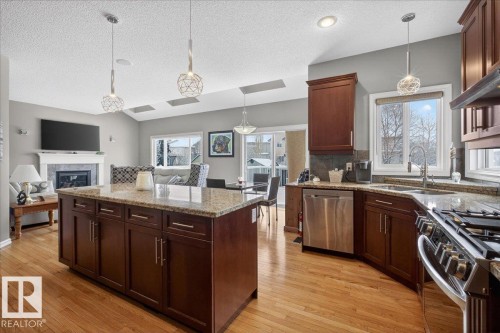 942 Chahley Crescent, Edmonton, AB - Indoor Photo Showing Kitchen With Fireplace