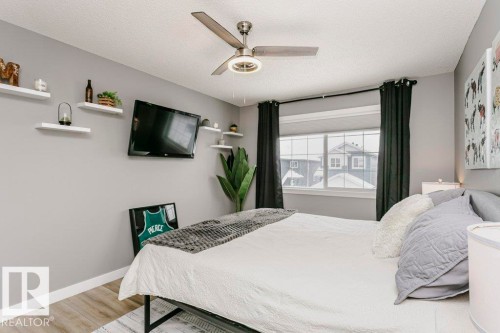 This room features light grey walls, a window with dark curtains, and light-colored flooring - 320 Balsam Link, Leduc, AB - Indoor Photo Showing Bedroom