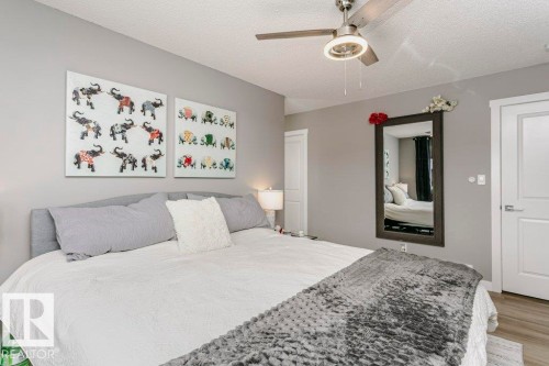 This bedroom features light gray walls, a ceiling fan with integrated lighting, and light-colored flooring - 320 Balsam Link, Leduc, AB - Indoor Photo Showing Bedroom