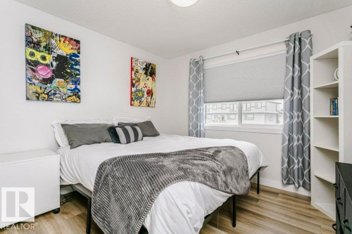 This room features light-colored flooring, a window with blinds, and white walls - 320 Balsam Link, Leduc, AB - Indoor Photo Showing Bedroom