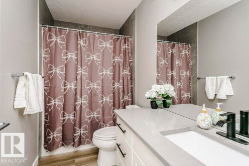 Well-appointed bathroom featuring a vanity with a light-colored countertop and an undermount sink - 320 Balsam Link, Leduc, AB - Indoor Photo Showing Bathroom