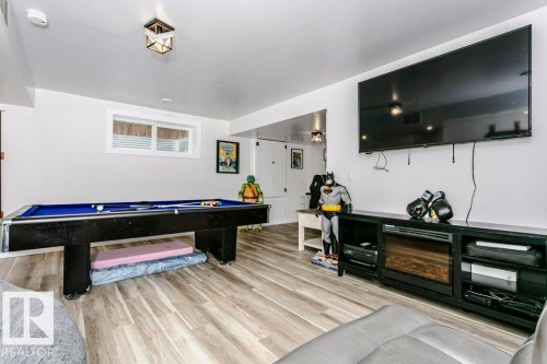 Entertainment space featuring light-colored flooring, a wall-mounted television, and a pool table - 320 Balsam Link, Leduc, AB - Indoor Photo Showing Other Room