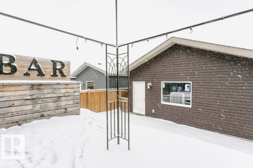 Outdoor area featuring a structure with decorative metalwork and overhead string lights - 320 Balsam Link, Leduc, AB - Outdoor