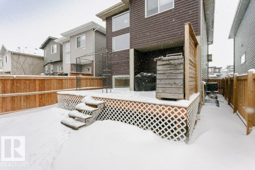 The property features a fenced yard with a deck, complete with stairs for access - 320 Balsam Link, Leduc, AB - Outdoor With Deck Patio Veranda With Exterior
