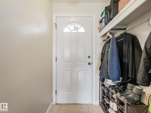 Entryway featuring a white door with an arched window and tiled flooring - 16106 79A Avenue Nw, Edmonton, AB - Indoor