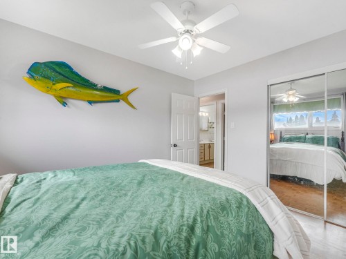 This room features a ceiling fan, a mirrored closet, and light-colored walls - 16106 79A Avenue Nw, Edmonton, AB - Indoor Photo Showing Bedroom