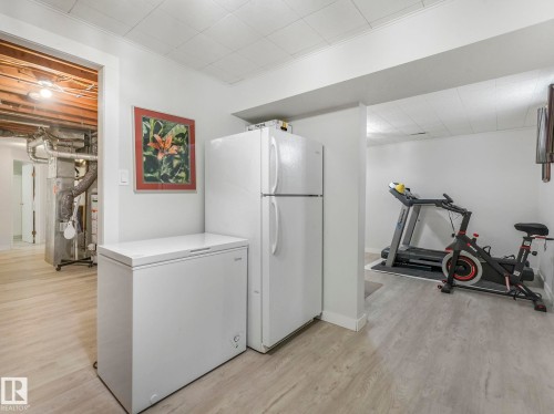 This versatile space features light-toned flooring - 16106 79A Avenue Nw, Edmonton, AB - Indoor Photo Showing Gym Room