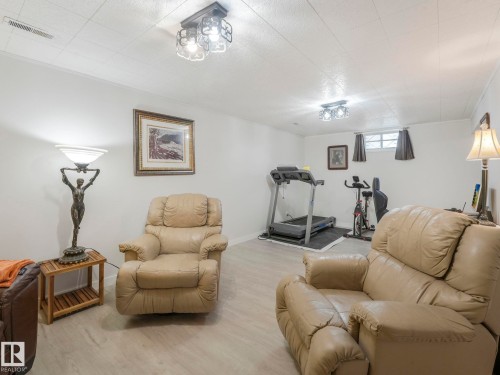 The property features light-colored flooring, white walls, and a ceiling - 16106 79A Avenue Nw, Edmonton, AB - Indoor Photo Showing Gym Room