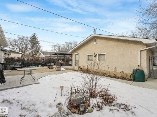 The property features a concrete patio area and a fenced side yard - 16106 79A Avenue Nw, Edmonton, AB - Outdoor