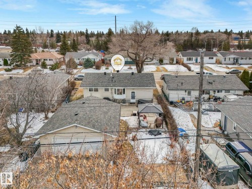 This property features a detached garage with a light-colored exterior and a dark shingled roof, offering practical outdoor storage and parking - 16106 79A Avenue Nw, Edmonton, AB - Outdoor