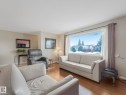 Living room featuring a large window providing views of the neighborhood - 16106 79A Avenue Nw, Edmonton, AB  - Indoor Photo Showing Living Room 