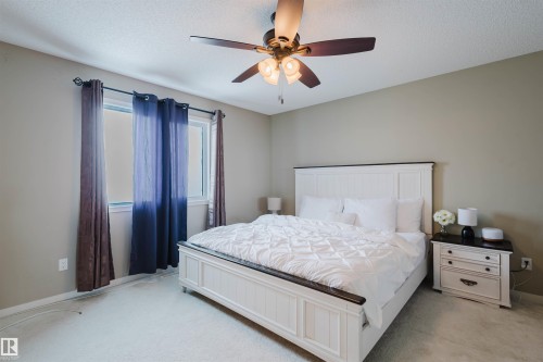 Bedroom with a ceiling fan, a window with curtains, and light-colored walls - 16811 120 Street, Edmonton, AB - Indoor Photo Showing Bedroom