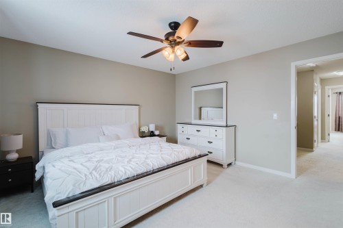 Bedroom featuring light neutral-toned walls, carpeted flooring, and a ceiling fan with integrated lighting - 16811 120 Street, Edmonton, AB - Indoor Photo Showing Bedroom