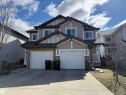 The property features a two-story design with light-colored siding and dark trim accents - 16811 120 Street, Edmonton, AB  - Outdoor With Facade 