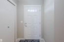 Welcoming entryway featuring a paneled door with an upper window, light-colored walls, and a convenient closet - 16811 120 Street, Edmonton, AB  - Indoor Photo Showing Other Room 