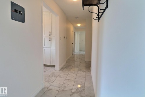 Corridor featuring baseboards and light marble finish floors - 304 11907 81 Street, Edmonton, AB - Indoor Photo Showing Other Room