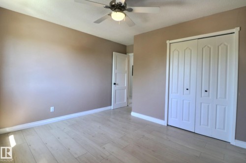 Unfurnished bedroom featuring a ceiling fan, a closet, and light wood finished floors - 304 11907 81 Street, Edmonton, AB - Indoor Photo Showing Other Room