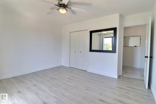 Unfurnished bedroom with light wood-style flooring, ceiling fan, and a closet - 304 11907 81 Street, Edmonton, AB - Indoor Photo Showing Other Room