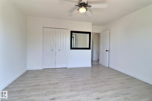 Unfurnished bedroom featuring light wood-style floors, ceiling fan, and a closet - 304 11907 81 Street, Edmonton, AB - Indoor Photo Showing Other Room