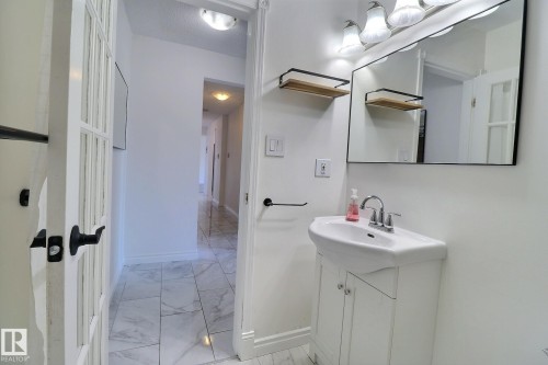 Bathroom featuring vanity and light marble finish flooring - 304 11907 81 Street, Edmonton, AB - Indoor Photo Showing Other Room