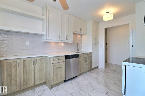Kitchen featuring white appliances, open shelves, a ceiling fan, light marble finish flooring, and tasteful backsplash - 304 11907 81 Street, Edmonton, AB - Indoor Photo Showing Kitchen With Upgraded Kitchen