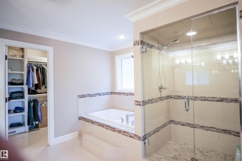 The bathroom features a spacious glass-enclosed shower with a tiled floor and a built-in bathtub with tiled surrounds - 4016 Mactaggart Drive, Edmonton, AB - Indoor Photo Showing Bathroom