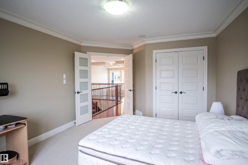 The room features crown molding and a neutral color palette - 4016 Mactaggart Drive, Edmonton, AB - Indoor Photo Showing Bedroom