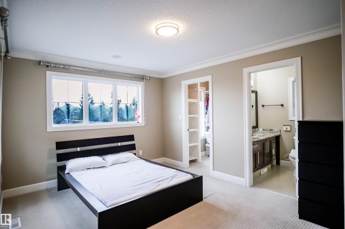 This room features neutral-toned walls, carpeting, and a window providing natural light - 4016 Mactaggart Drive, Edmonton, AB - Indoor Photo Showing Bedroom