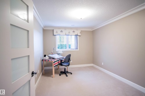 This room features a window providing natural light, crown molding, and neutral-toned walls - 4016 Mactaggart Drive, Edmonton, AB - Indoor Photo Showing Office