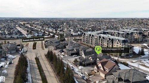 Aerial view showcasing the property's location within a developed neighborhood, featuring residential streets and varying architectural styles - 4016 Mactaggart Drive, Edmonton, AB - Outdoor With View