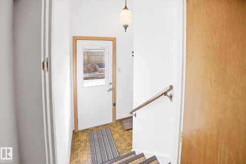 Entryway featuring a light wood doorframe and a white door with a window - 6503 106A Avenue, Edmonton, AB - Indoor Photo Showing Other Room