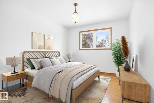 This room features light hardwood flooring and a window with a wood frame - 6503 106A Avenue, Edmonton, AB - Indoor Photo Showing Bedroom