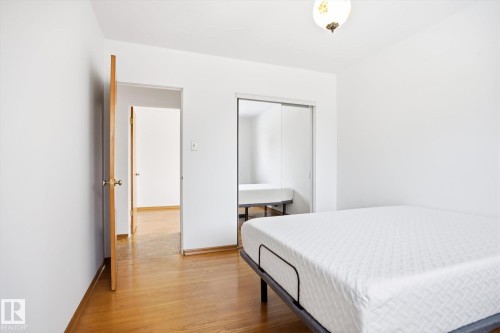This room features hardwood floors and a white ceiling with a decorative light fixture - 6503 106A Avenue, Edmonton, AB - Indoor Photo Showing Other Room