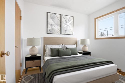 This room features a window with wood trim, white walls, and wood flooring - 6503 106A Avenue, Edmonton, AB - Indoor Photo Showing Bedroom