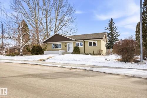 The property features a ranch-style exterior with a light-colored facade and a dark brown roof - 6503 106A Avenue, Edmonton, AB - Outdoor With Facade
