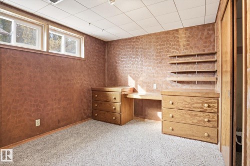 This room features built-in wooden shelving, a desk, and drawers, offering practical storage and workspace solutions - 6503 106A Avenue, Edmonton, AB - Indoor Photo Showing Other Room