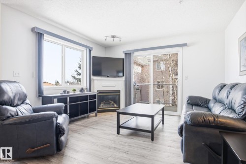 306 5116 49 Avenue, Leduc, AB - Indoor Photo Showing Living Room With Fireplace