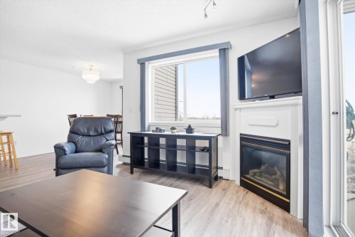 306 5116 49 Avenue, Leduc, AB - Indoor Photo Showing Living Room With Fireplace