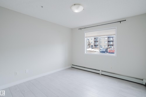 The room features light-colored flooring and white walls, creating a bright and airy atmosphere - 113 309 Clareview Station Drive, Edmonton, AB - Indoor Photo Showing Other Room