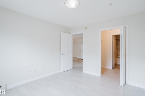 This room features light-colored flooring and white walls, creating a bright and airy atmosphere - 113 309 Clareview Station Drive, Edmonton, AB - Indoor Photo Showing Other Room