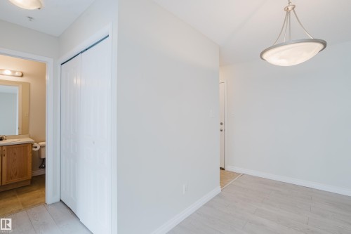 The interior features light-colored walls, light-toned flooring, and a modern ceiling light fixture - 113 309 Clareview Station Drive, Edmonton, AB - Indoor Photo Showing Other Room