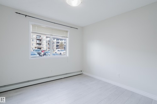 This room features light-toned flooring, a window with blinds, and light-colored walls - 113 309 Clareview Station Drive, Edmonton, AB - Indoor Photo Showing Other Room