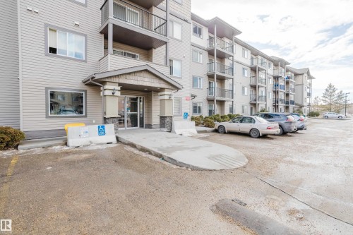 The property features an exterior with light-colored siding and an entrance with a covered porch - 113 309 Clareview Station Drive, Edmonton, AB - Outdoor