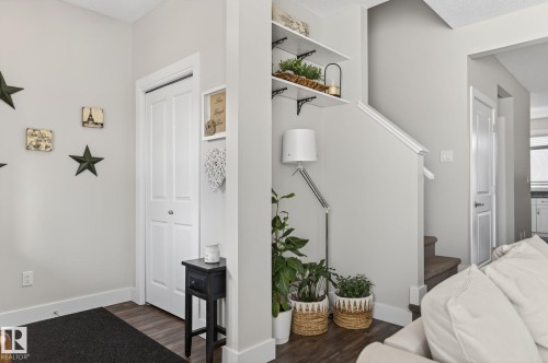 The property features contemporary light grey walls, dark plank flooring, and white baseboards - 9084 Rosenthal Link, Edmonton, AB - Indoor